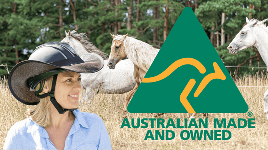 Australian Made Helmet Brim for Horse Riders who value sun safety. Image of woman wearing helmet and Helmet Brim (black) with paddock with three horses behind her.