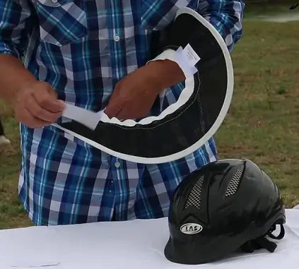 taking-velcro-tab-off-helmet-brim-to-put-on-helmet